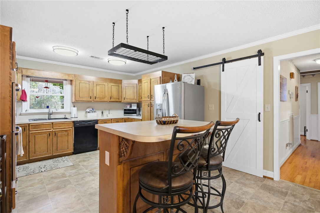 1005 Pinecroft Drive Anderson, SC 29621 - Photo 23 of 50 This spacious kitchen offers a functional island, ample cabinetry, and modern appliances for daily living.