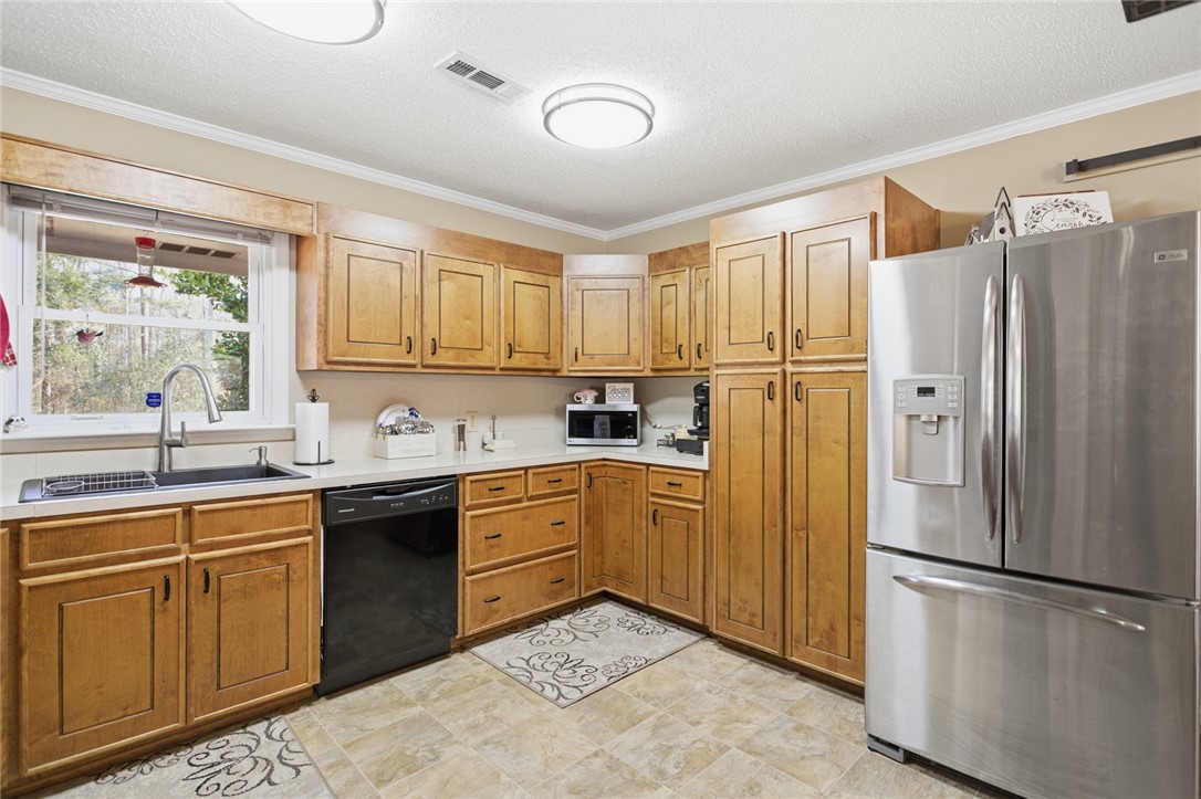 1005 Pinecroft Drive Anderson, SC 29621 - Photo 24 of 50 This bright kitchen features ample cabinetry and modern appliances, creating a comfortable and functional space.