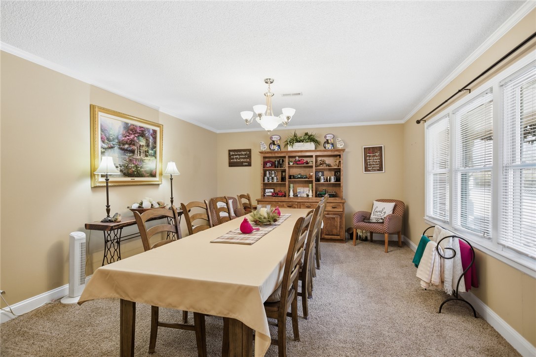 1005 Pinecroft Drive Anderson, SC 29621 - Photo 27 of 50 This inviting dining room features ample space for entertaining and elegant crown molding.