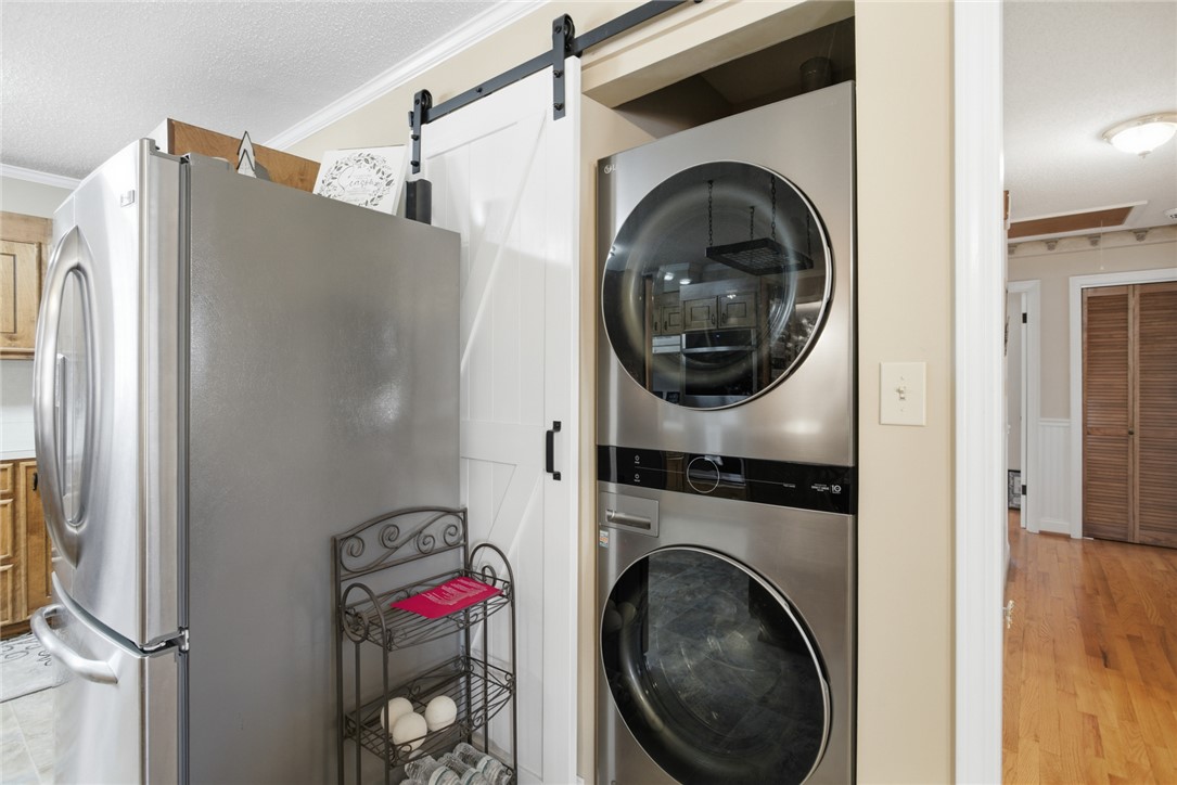 1005 Pinecroft Drive Anderson, SC 29621 - Photo 31 of 50 This functional space seamlessly integrates a washer/dryer with a sliding barn door for optimal organization.