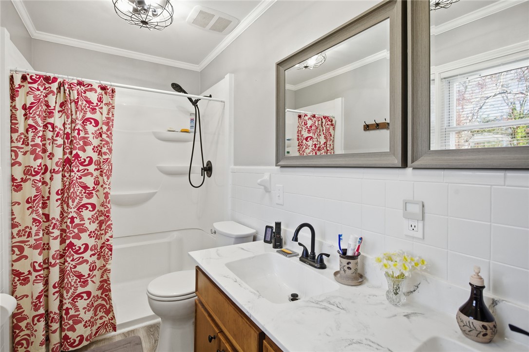 1005 Pinecroft Drive Anderson, SC 29621 - Photo 36 of 50 This bathroom features a sleek vanity with a tub and shower combination.