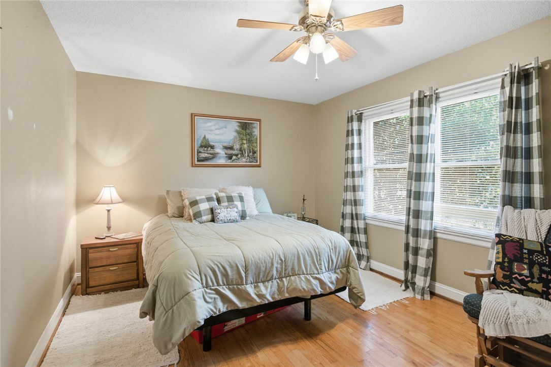 1005 Pinecroft Drive Anderson, SC 29621 - Photo 39 of 50 This inviting bedroom features natural light and rich wood flooring, perfect for serene relaxation.