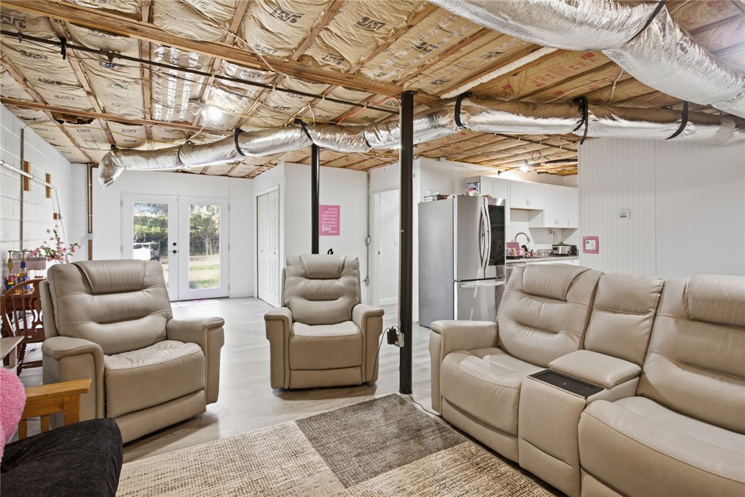 1005 Pinecroft Drive Anderson, SC 29621 - Photo 43 of 50 This versatile basement space offers comfortable living with exposed ceilings and convenient access to the outdoors.