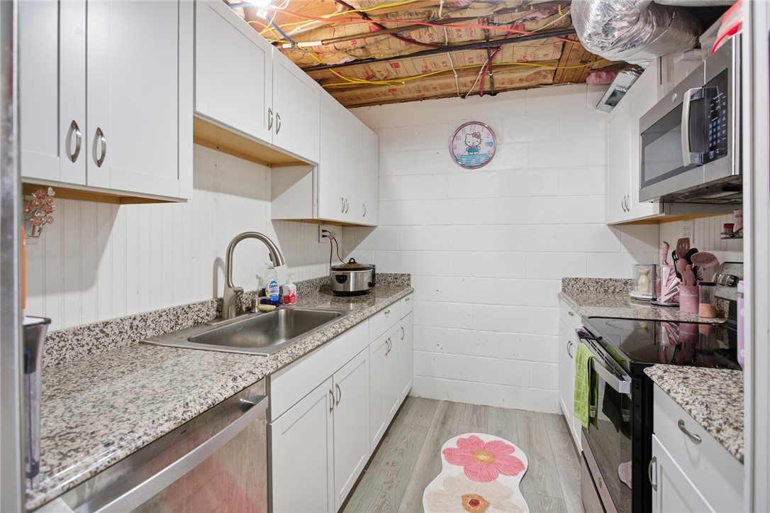 1005 Pinecroft Drive Anderson, SC 29621 - Photo 46 of 50 This functional kitchen space features white cabinetry and granite countertops, perfect for daily tasks.