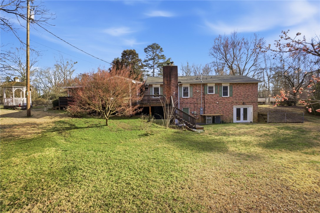 1005 Pinecroft Drive Anderson, SC 29621 - Photo 6 of 50 This spacious backyard features a gazebo and ample green space, perfect for outdoor activities and relaxation.