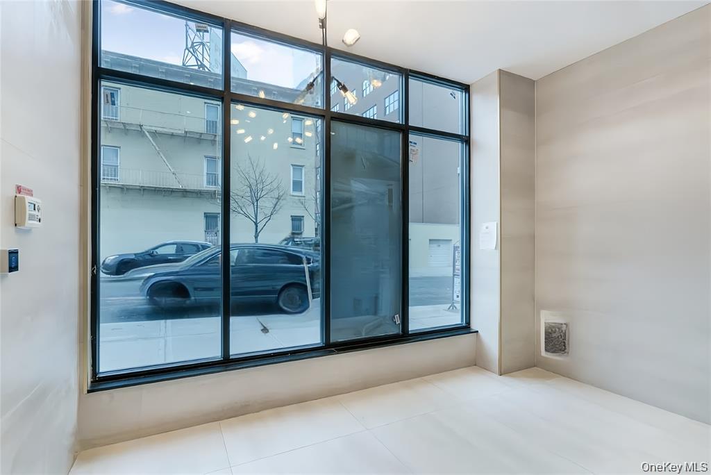 41-04 27th Street, Unit 8C Queens, NY 11101 - Photo 6 of 9 a bathroom with a glass shower door