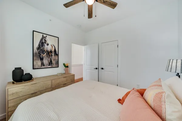 a bedroom with a large bed and a chandelier
