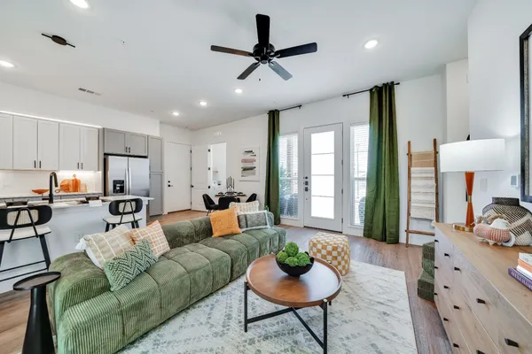 a living room with furniture or couch and a view of kitchen