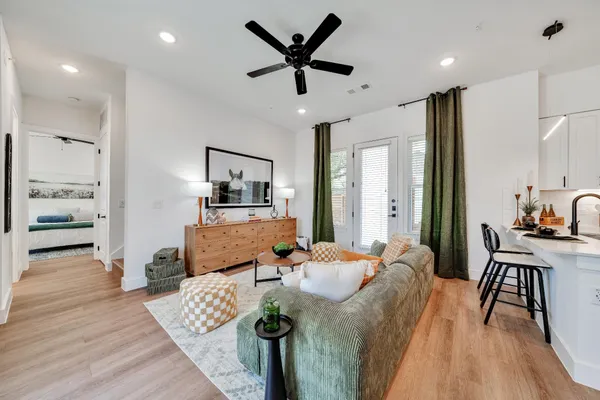 a living room with furniture and wooden floor