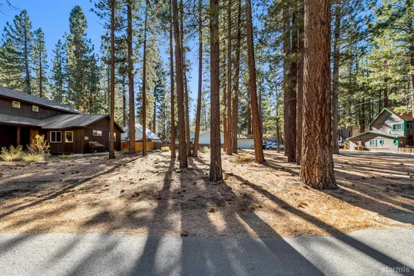 a view of a house with a yard and tree s