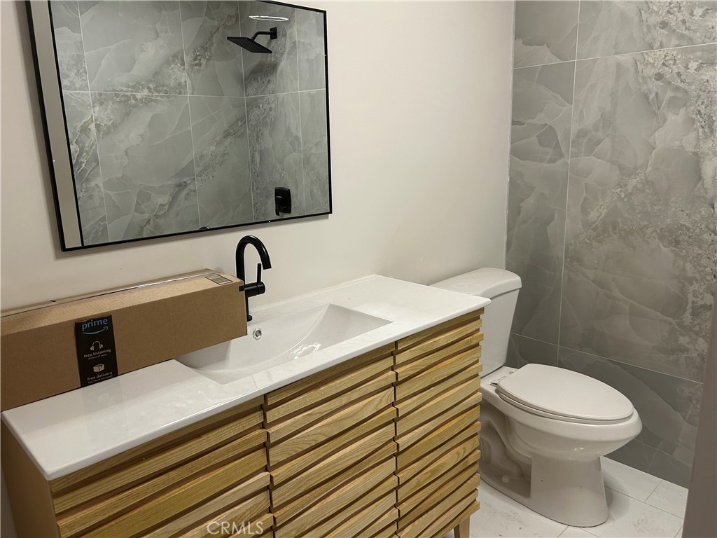 3375 Baltic Avenue Long Beach, CA 90810 - Photo 11 of 24 a bathroom with a sink toilet and vanity