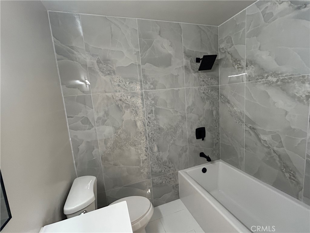 3375 Baltic Avenue Long Beach, CA 90810 - Photo 13 of 24 a bathroom with a toilet and a bathtub