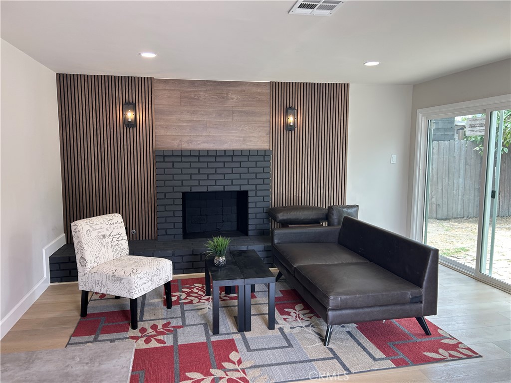 3375 Baltic Avenue Long Beach, CA 90810 - Photo 15 of 24 a living room with furniture and a fireplace