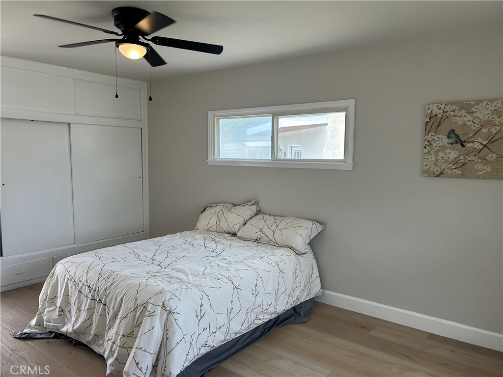 3375 Baltic Avenue Long Beach, CA 90810 - Photo 16 of 24 a bedroom with a bed and a chandelier