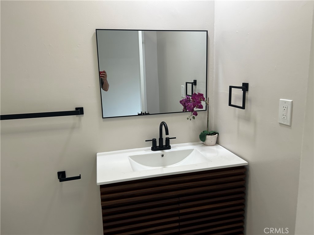 3375 Baltic Avenue Long Beach, CA 90810 - Photo 19 of 24 a bathroom with a sink and a mirror