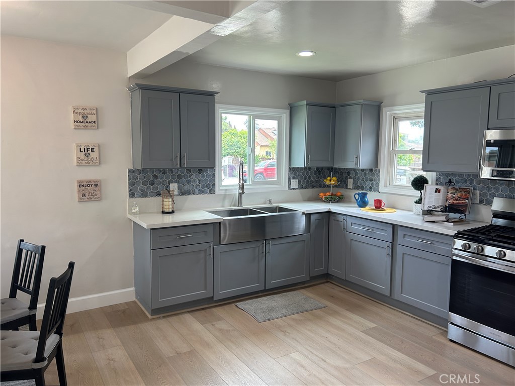 3375 Baltic Avenue Long Beach, CA 90810 - Photo 7 of 24 a kitchen with sink cabinets and window