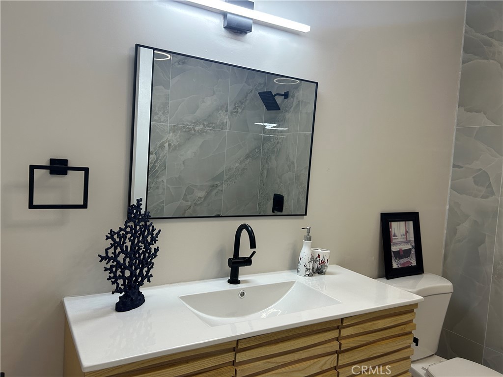 3375 Baltic Avenue Long Beach, CA 90810 - Photo 10 of 24 a bathroom with a sink and a mirror