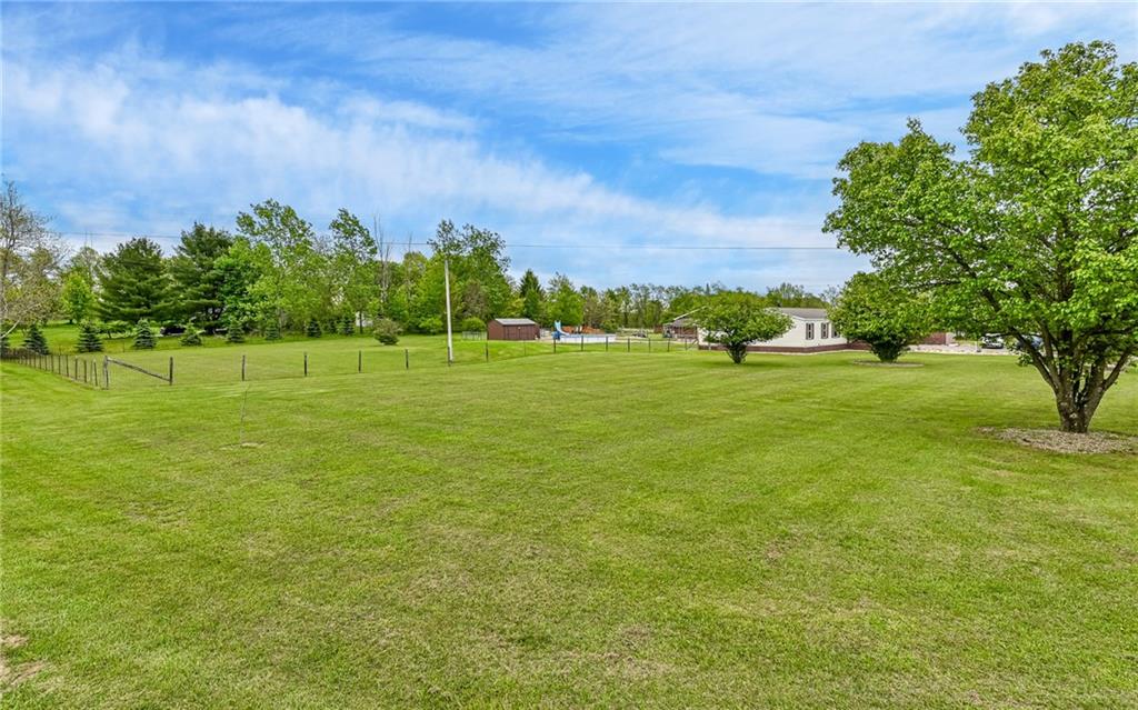 307 Hungarian Road Slippery Rock, PA 16057 - Photo 22 of 34 a view of a green field with trees in the background