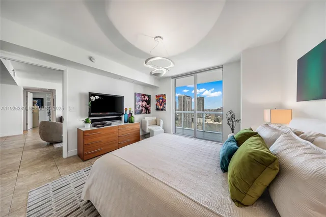 a bedroom with a bed and a television