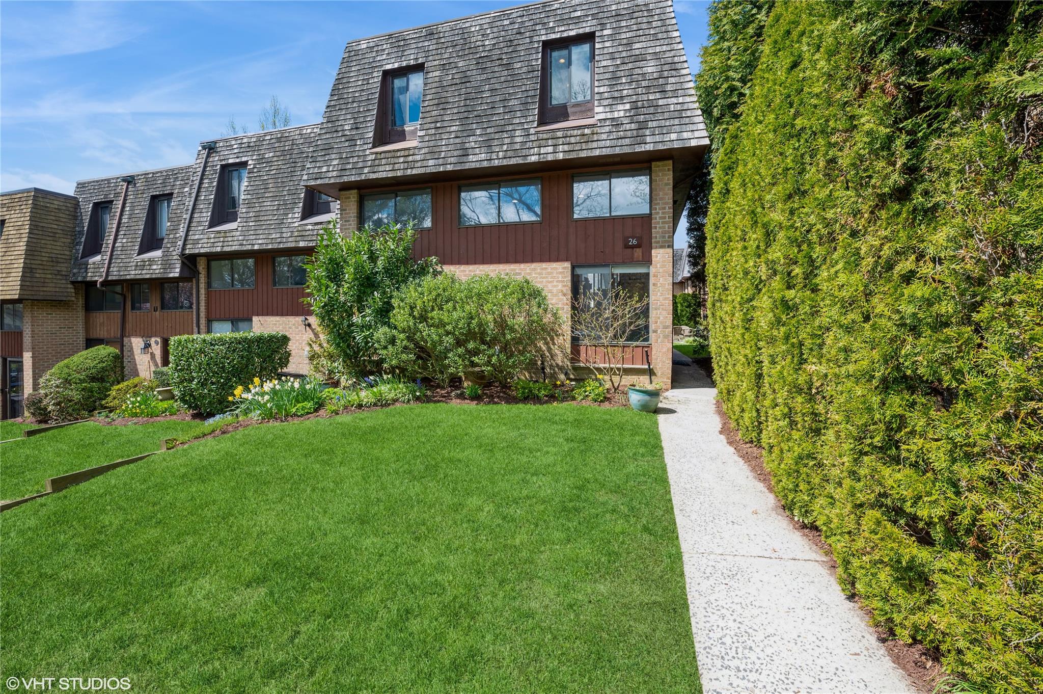 26 The Hamlet Pelham, NY 10803 - Photo 1 of 1 a view of a brick house with a yard