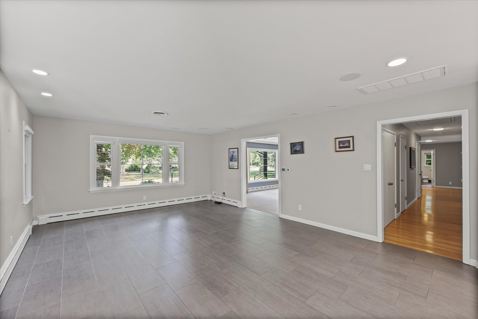 32 Greencroft Drive Champaign, IL 61821 - Photo 11 of 40 an empty room with wooden floor and windows