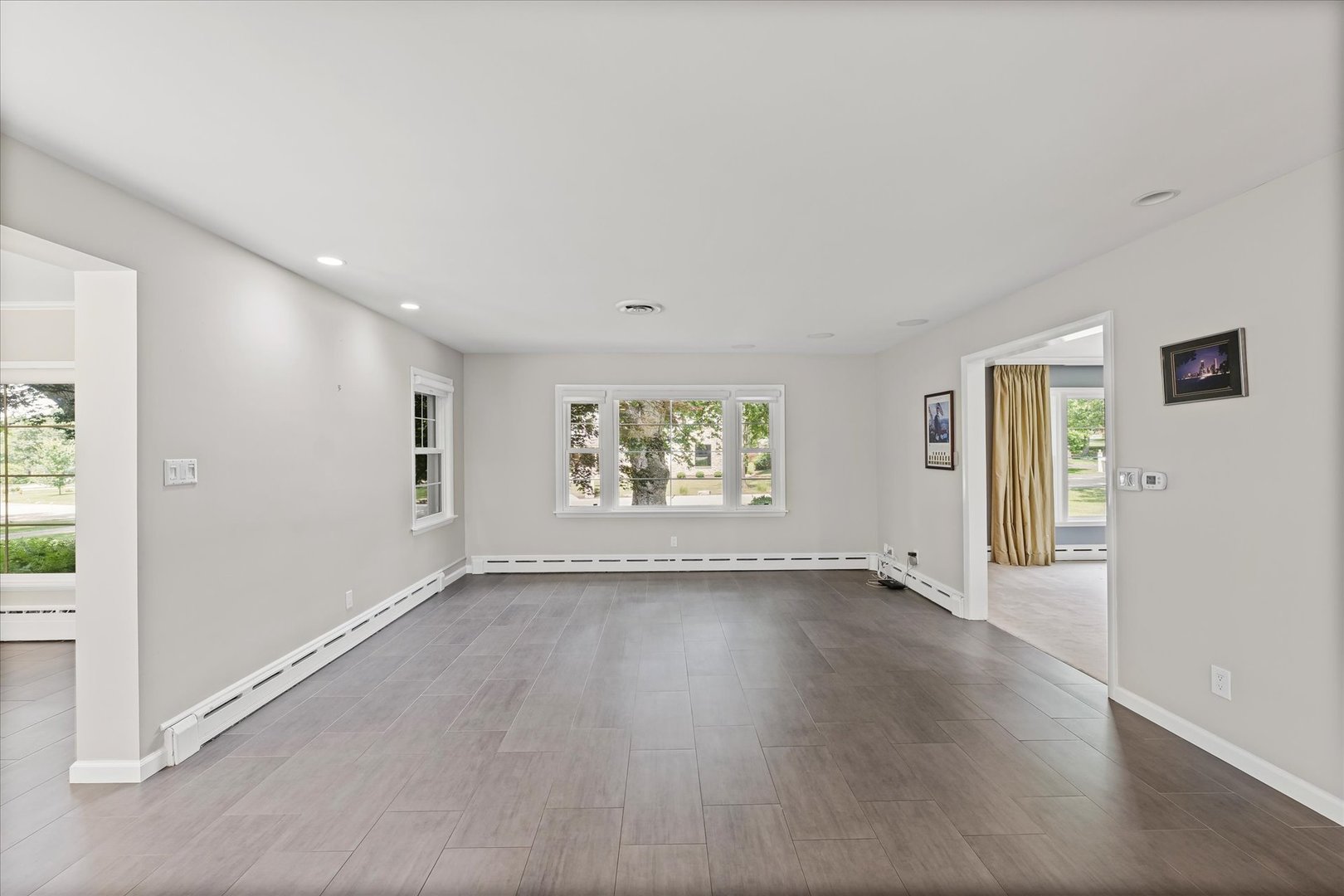 32 Greencroft Drive Champaign, IL 61821 - Photo 12 of 40 an empty room with wooden floor and windows