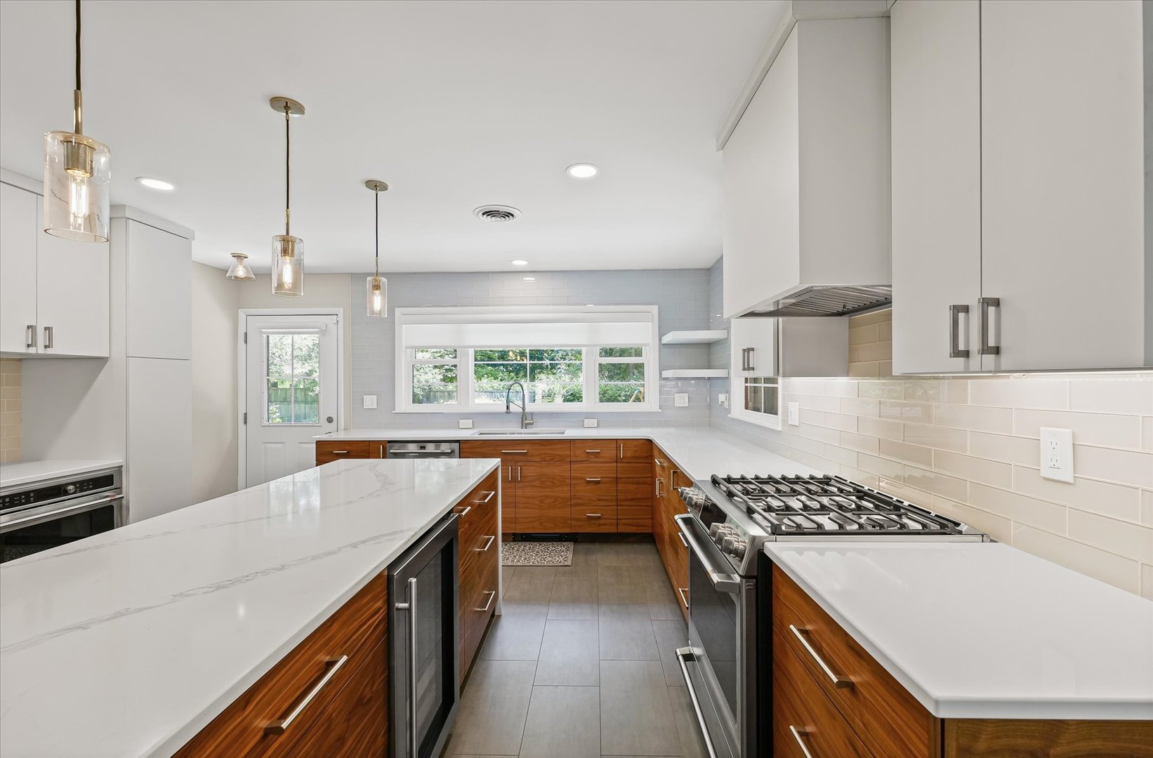 32 Greencroft Drive Champaign, IL 61821 - Photo 17 of 40 a kitchen with kitchen island a stove a sink a counter top space and cabinets
