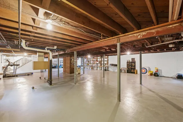 a backyard of a house with table and chairs floor to ceiling window and potted plants