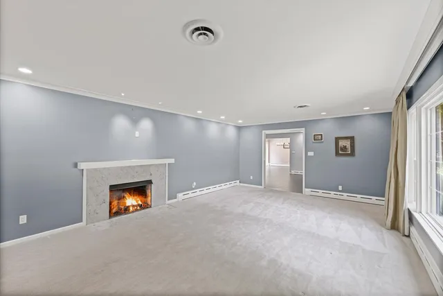 an empty room with a fireplace and a window