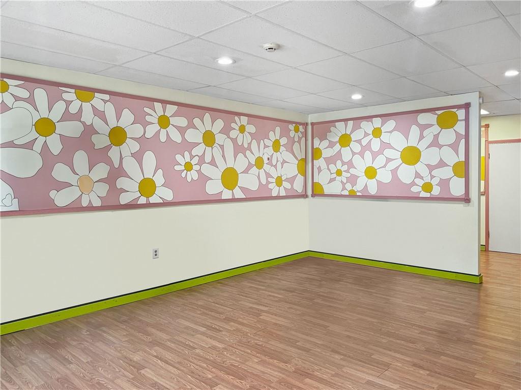 402 Loop, Unit LOOP Pittsburgh, PA 15215 - Photo 7 of 10 a view of room with window and wooden floor