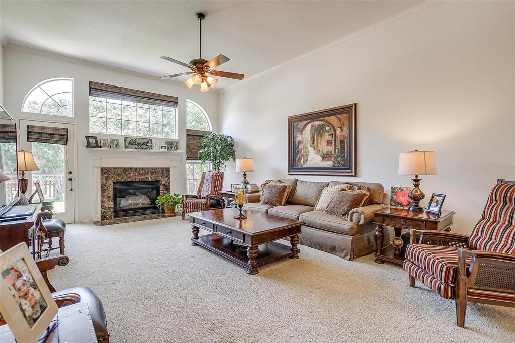 a living room with furniture a chandelier and a fireplace