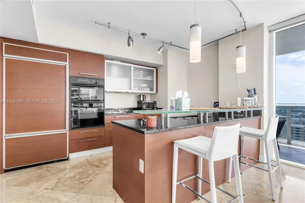 a living room with furniture and floor to ceiling window