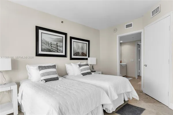 a bedroom with a bed and a large window