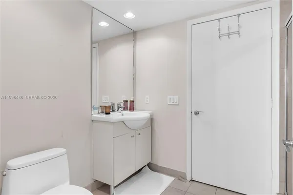 a bathroom with a glass shower door