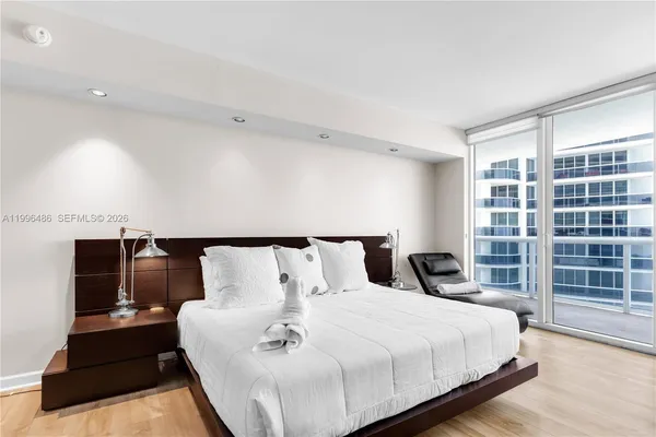 a bedroom with a bed and book shelf