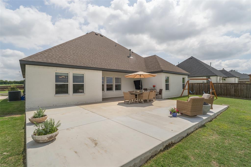 9424 Wildcat Ridge Godley, TX 76044 - Photo 23 of 25 a front view of house with yard outdoor seating and barbeque oven