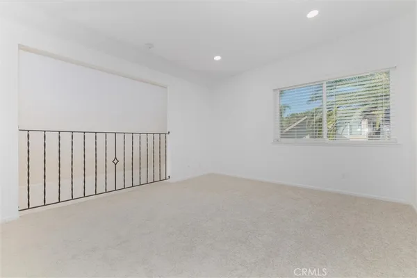 a view of a house with a small yard plants and large tree