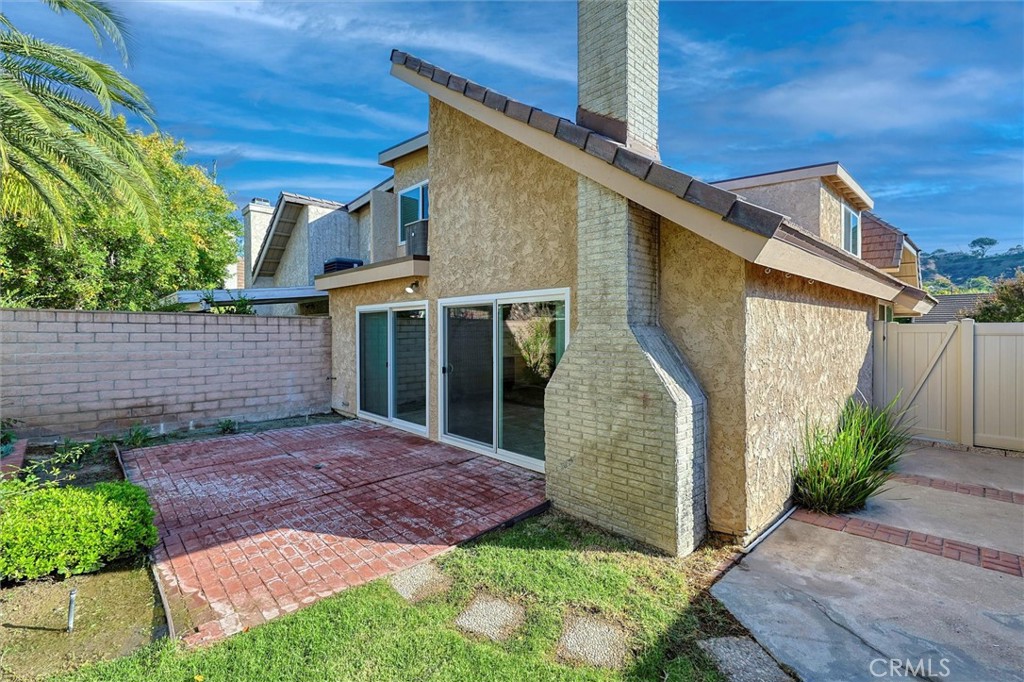 27139 Rio Prado Drive Valencia, CA 91354 - Photo 27 of 34 a view of a house with a small yard plants and large tree