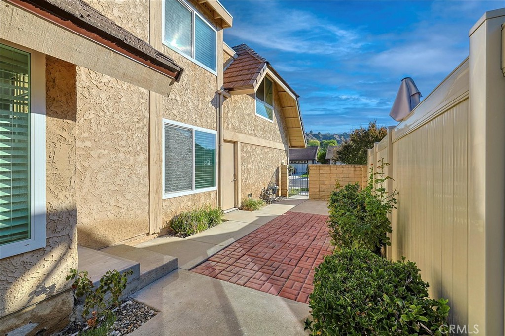 27139 Rio Prado Drive Valencia, CA 91354 - Photo 3 of 34 a front view of a house with a yard and outdoor space