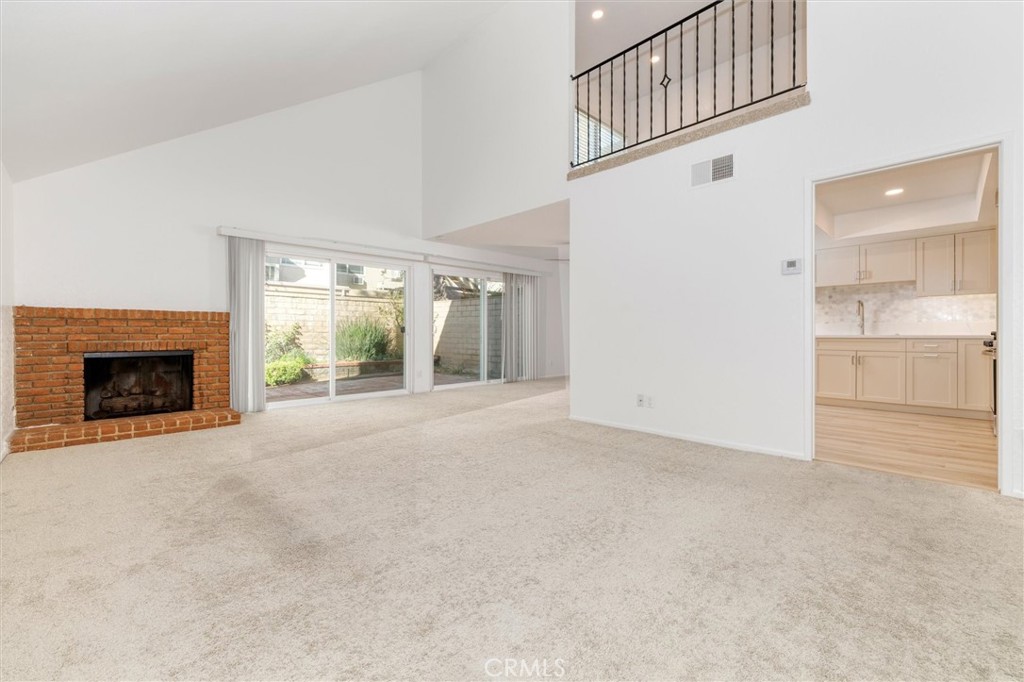 27139 Rio Prado Drive Valencia, CA 91354 - Photo 5 of 34 a view of an empty room with a fireplace and a window