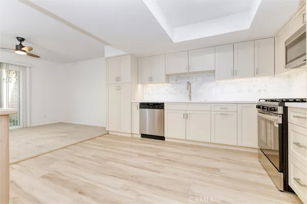 a view of a kitchen with electric appliances