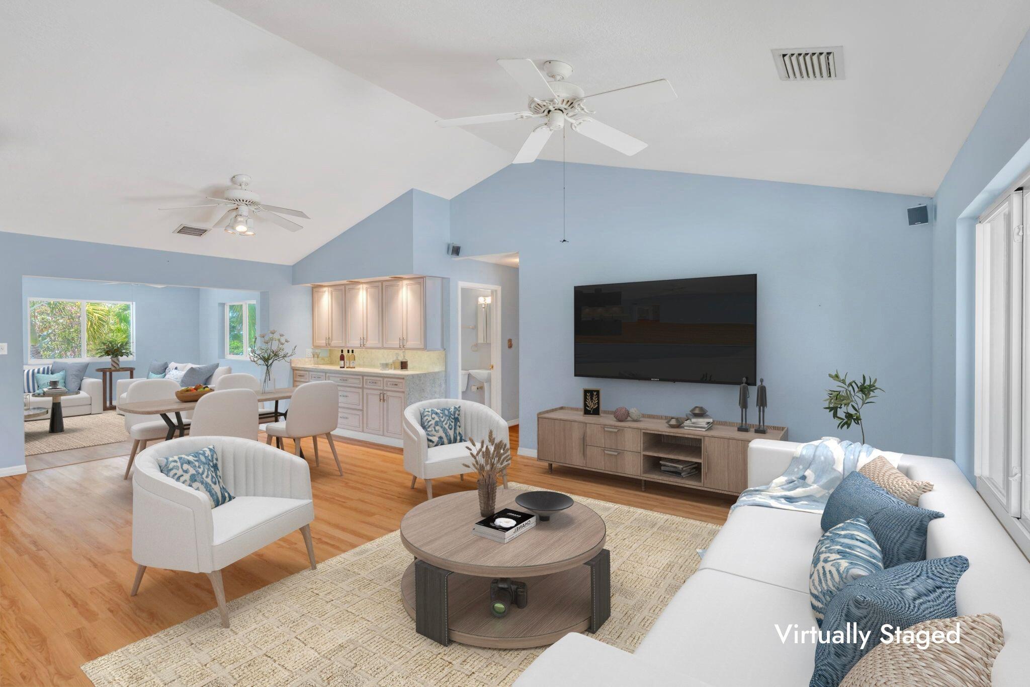 501 11th Street Key Colony Beach, FL 33051 - Photo 12 of 52 a living room with furniture a flat screen tv and a large window
