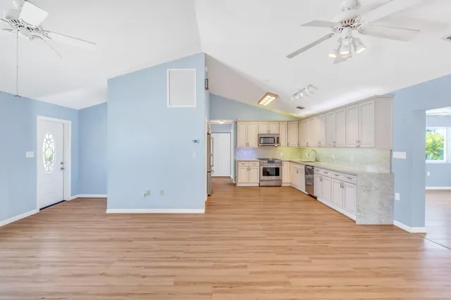 a view of a living room kitchen and a wooden floor