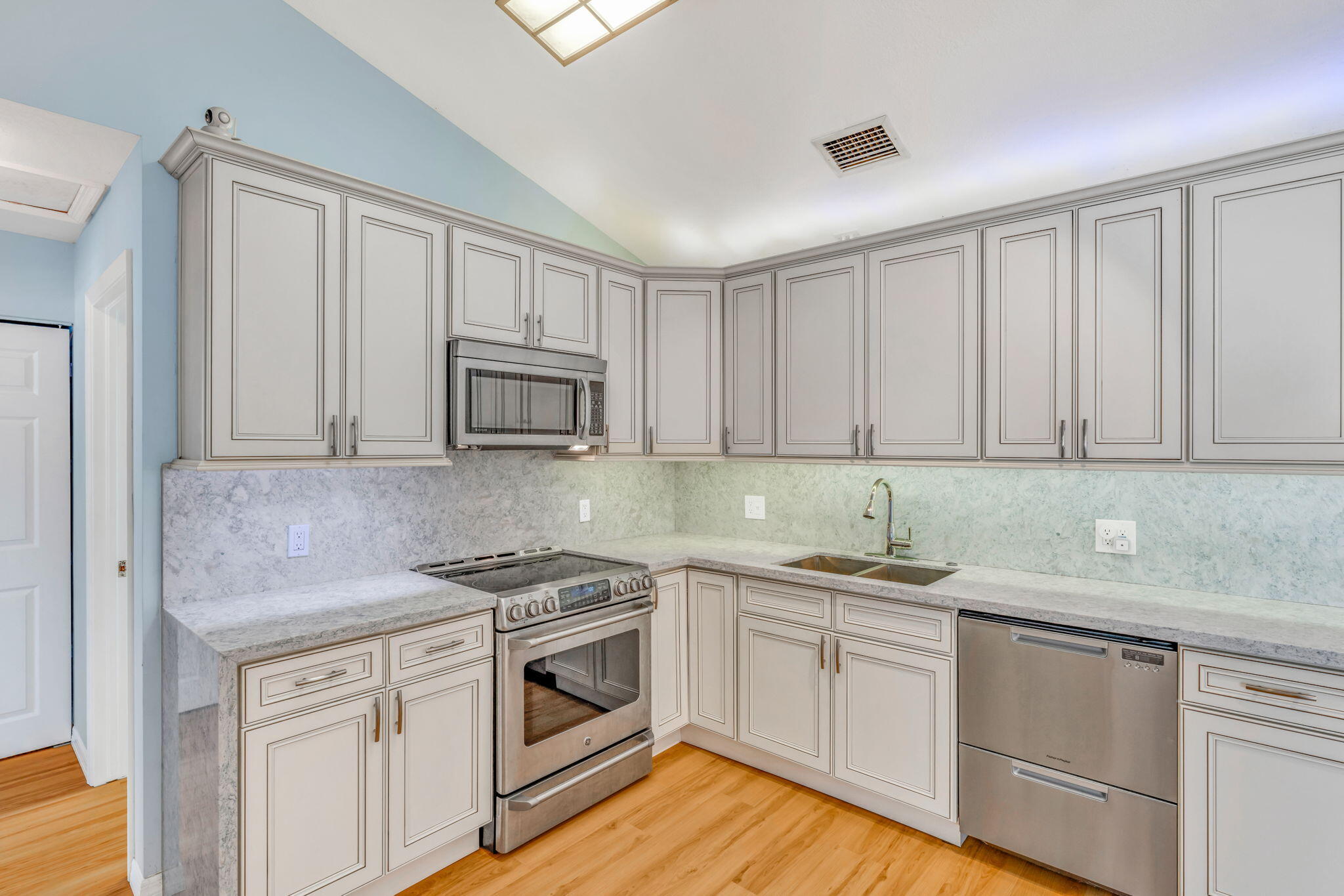501 11th Street Key Colony Beach, FL 33051 - Photo 19 of 52 a kitchen with granite countertop white cabinets and white appliances