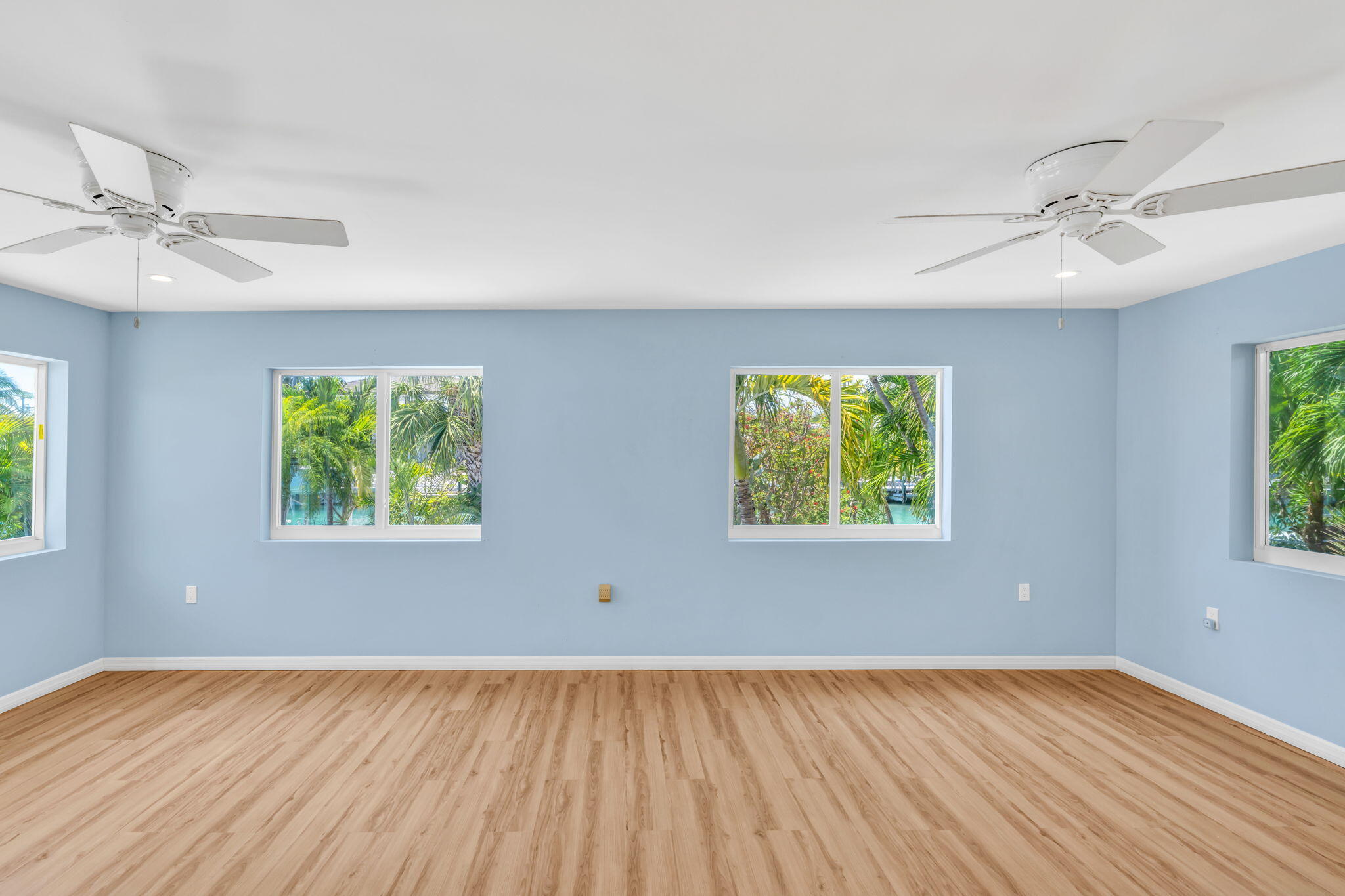 501 11th Street Key Colony Beach, FL 33051 - Photo 25 of 52 wooden floor in an empty room with a window