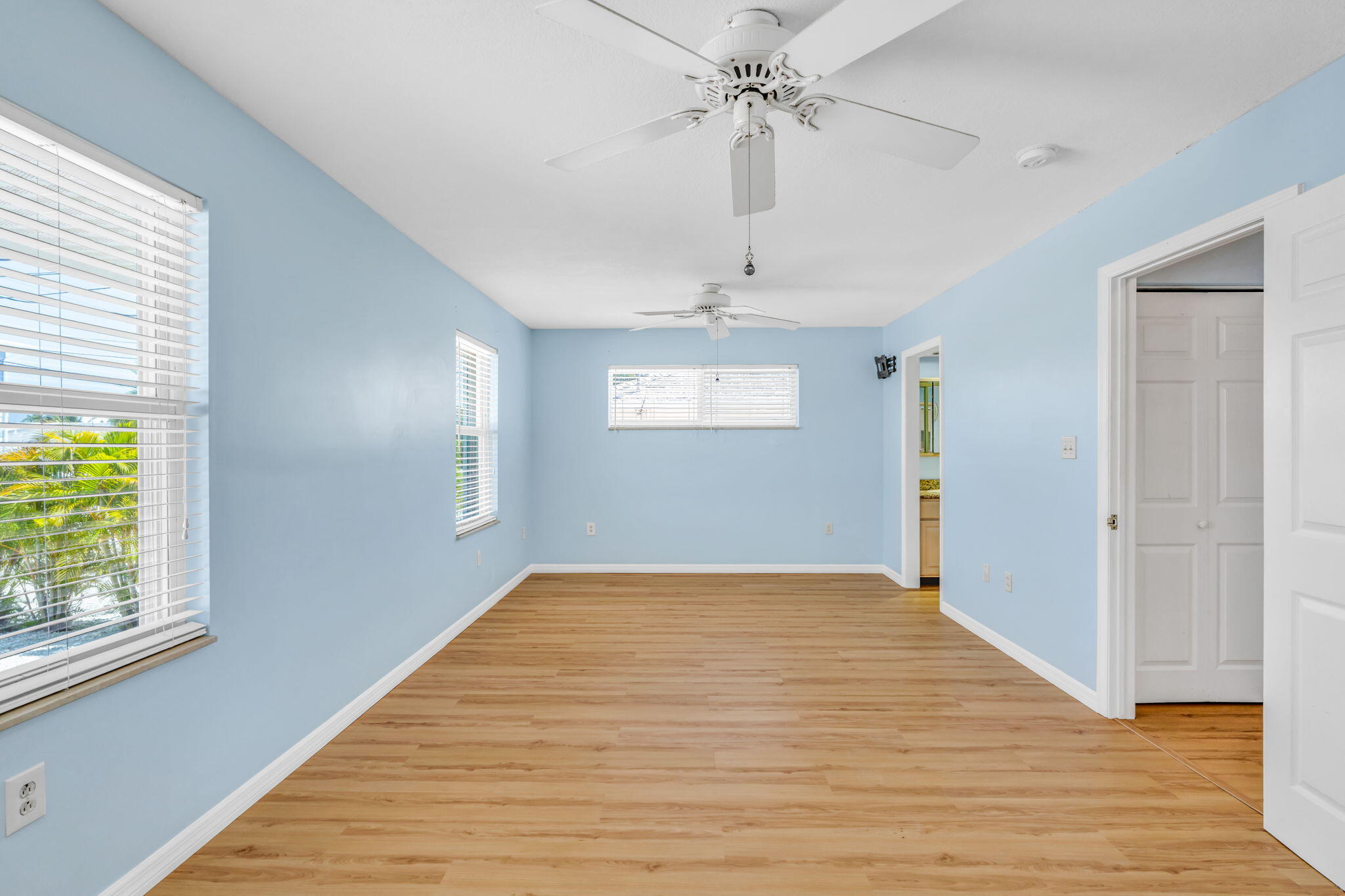 501 11th Street Key Colony Beach, FL 33051 - Photo 27 of 52 wooden floor in an empty room with a window