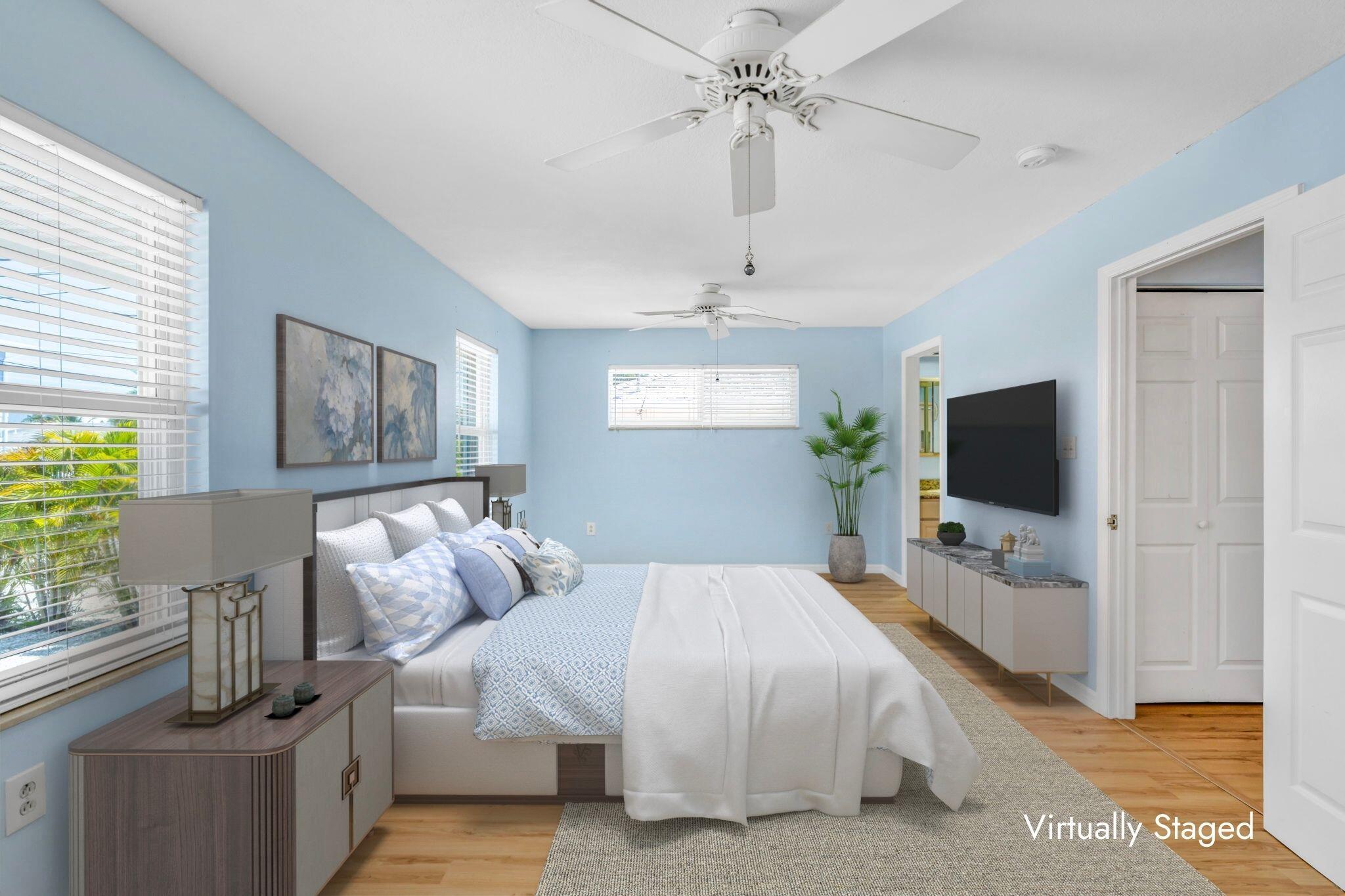 501 11th Street Key Colony Beach, FL 33051 - Photo 28 of 52 a bedroom with a bed and a flat screen tv