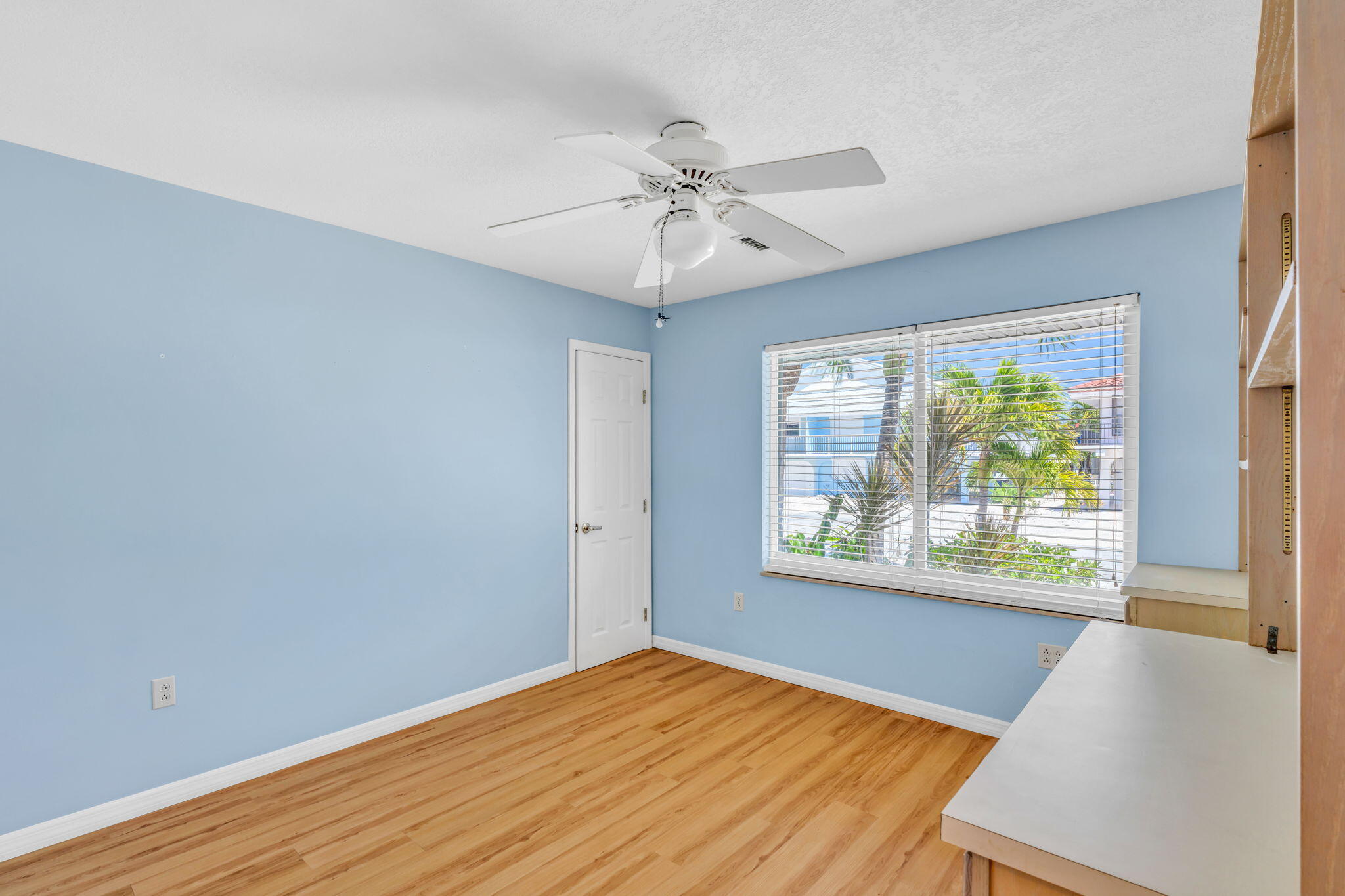 501 11th Street Key Colony Beach, FL 33051 - Photo 36 of 52 a view of an empty room with wooden floor and a window