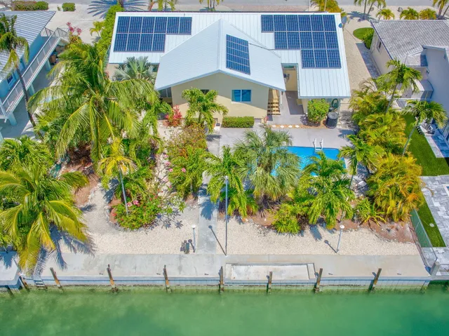 a view of a house with swimming pool and sitting area