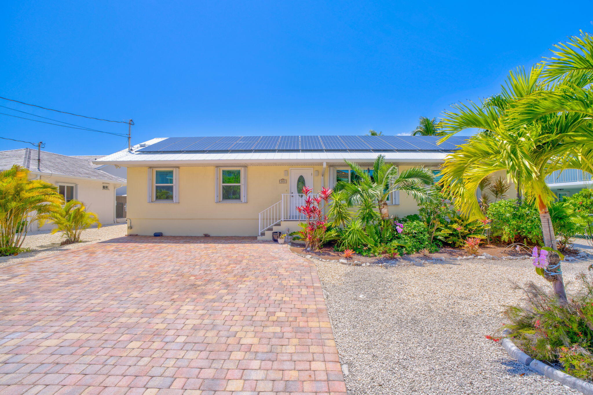 501 11th Street Key Colony Beach, FL 33051 - Photo 46 of 52 a backyard of a house with potted plants and palm trees